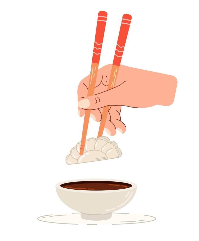 dopp gyoza i soja sås. kinesisk ätpinnar i hand. vektor