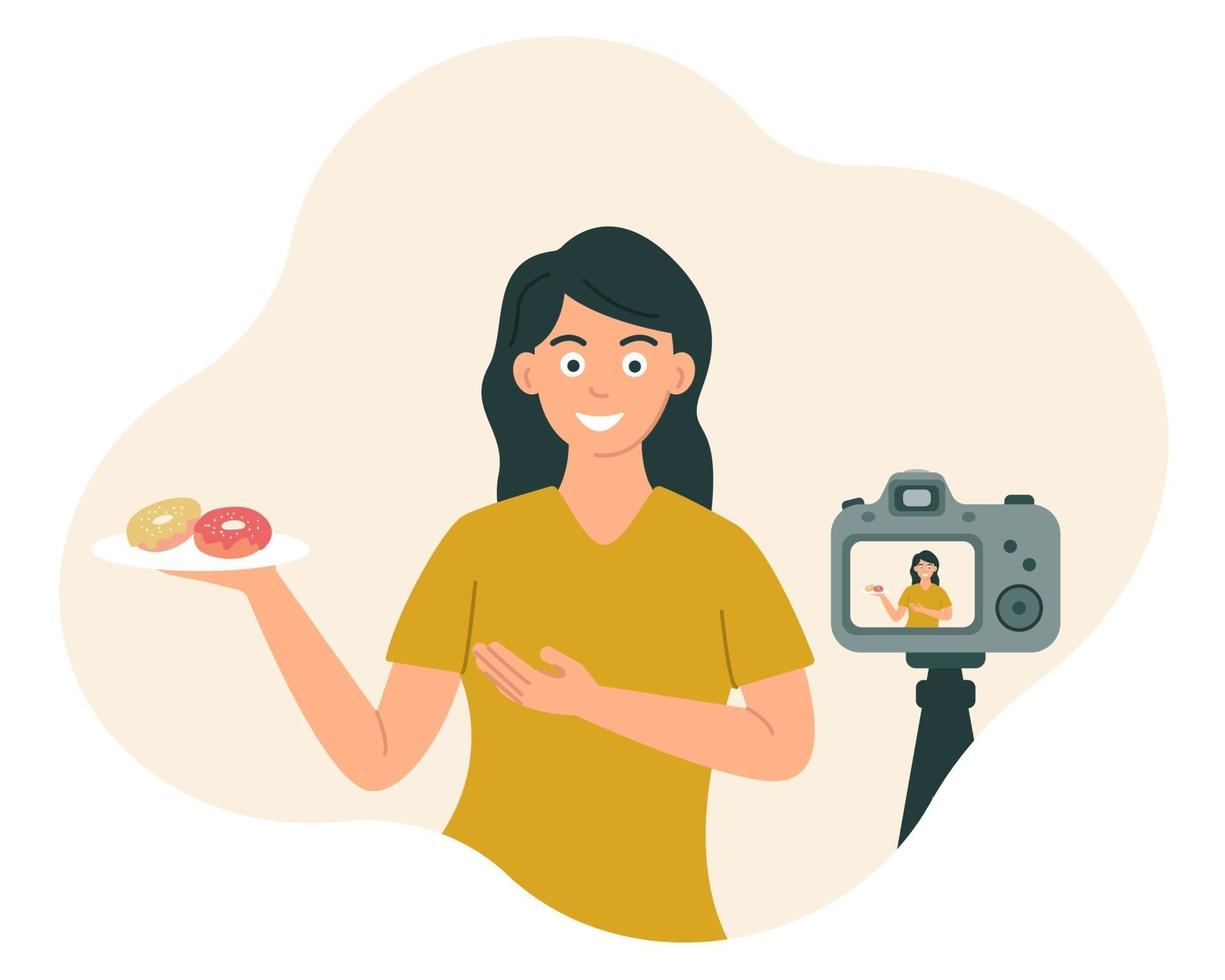 Food Blogger Eine Frau lächelt und zeigt Essen vor der Kamera, während sie ein Video, Foto aufzeichnet. vektor