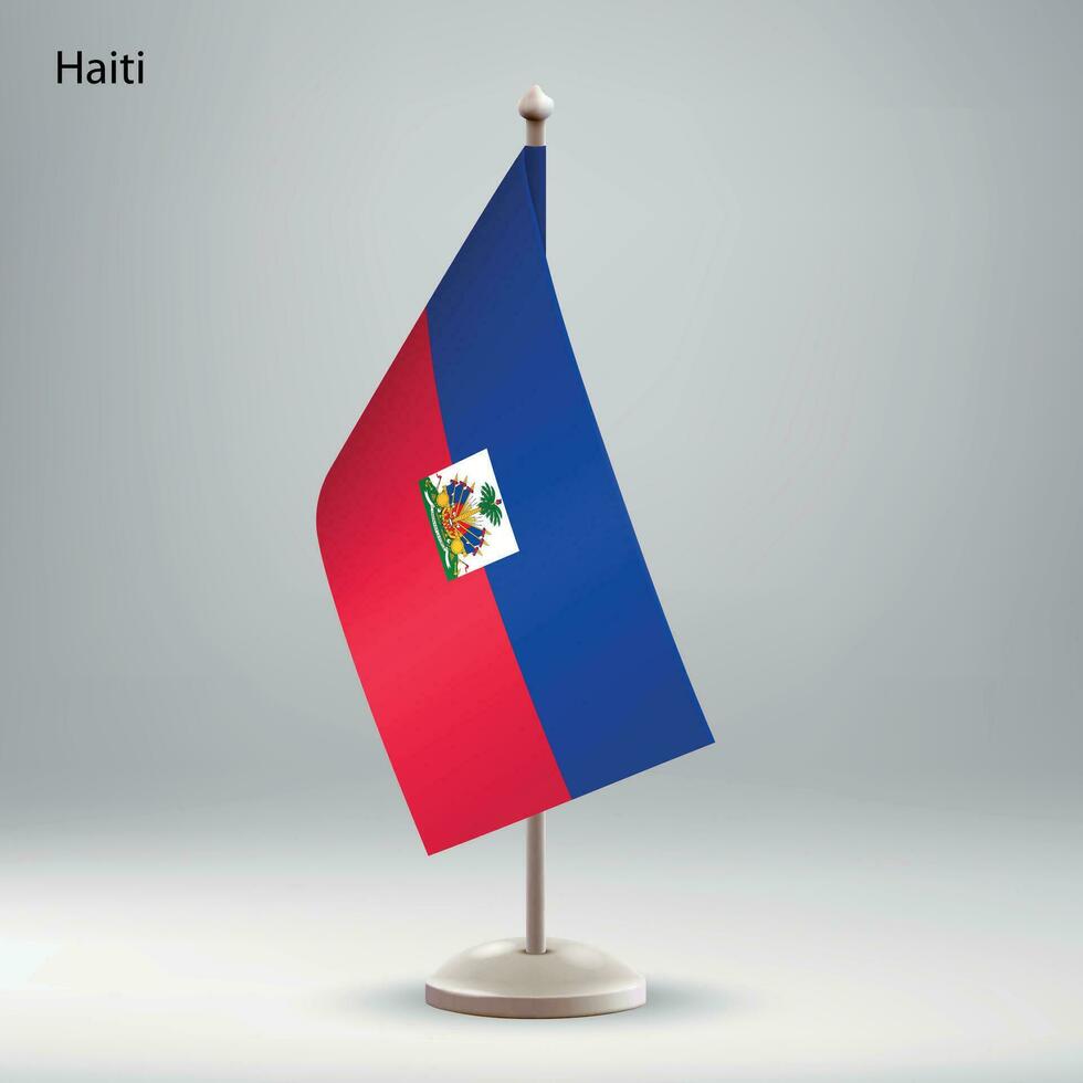 Flagge von Haiti hängend auf ein Flagge Stand. vektor