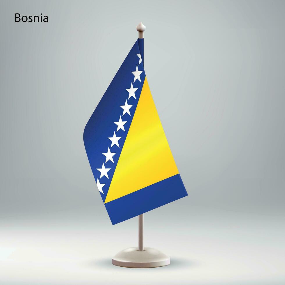 Flagge von Bosnien hängend auf ein Flagge Stand. vektor