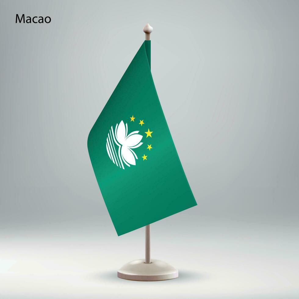 Flagge von Macao hängend auf ein Flagge Stand. vektor