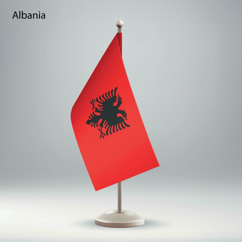 flagga av albania hängande på en flagga stå. vektor