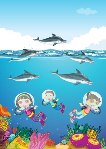 Delfiner och barn simma under havet vektor