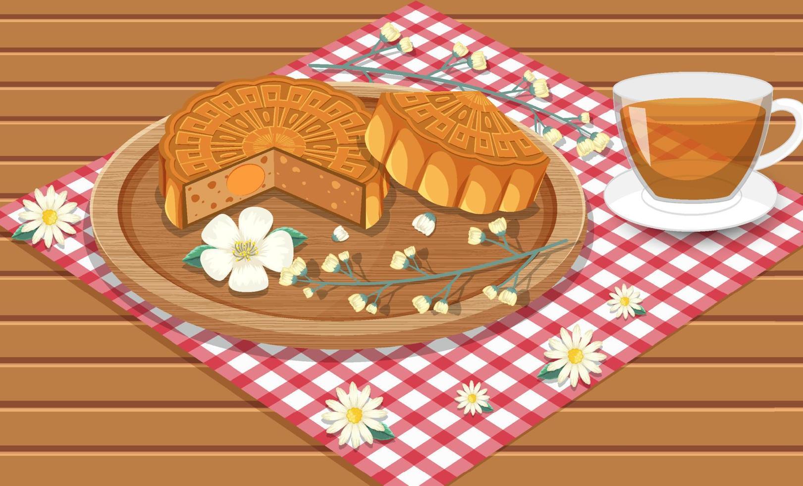 gesalzener Eigelb-Mondkuchen mit Teetasse auf Holztisch vektor