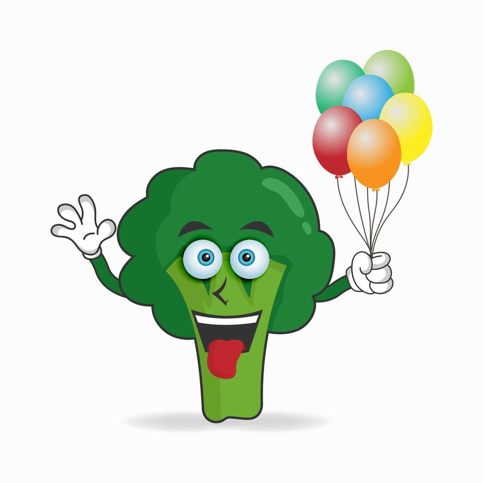 broccoli maskot karaktär som håller en ballong. vektor illustration