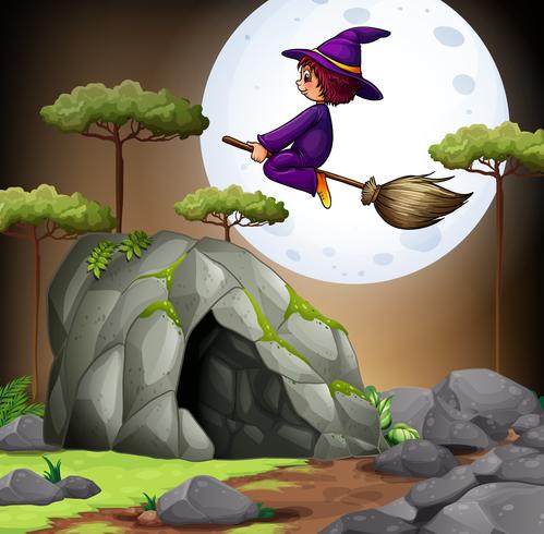 Hexe fliegt über die Höhle vektor