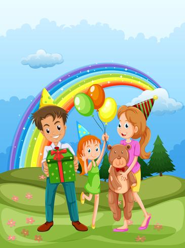 Eine glückliche Familie am Hügel und ein Regenbogen am Himmel vektor