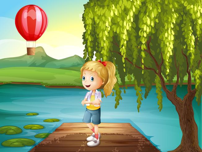 Ein Mädchen, das über der Holzbrücke mit einem Heißluftballon in der Nähe steht vektor