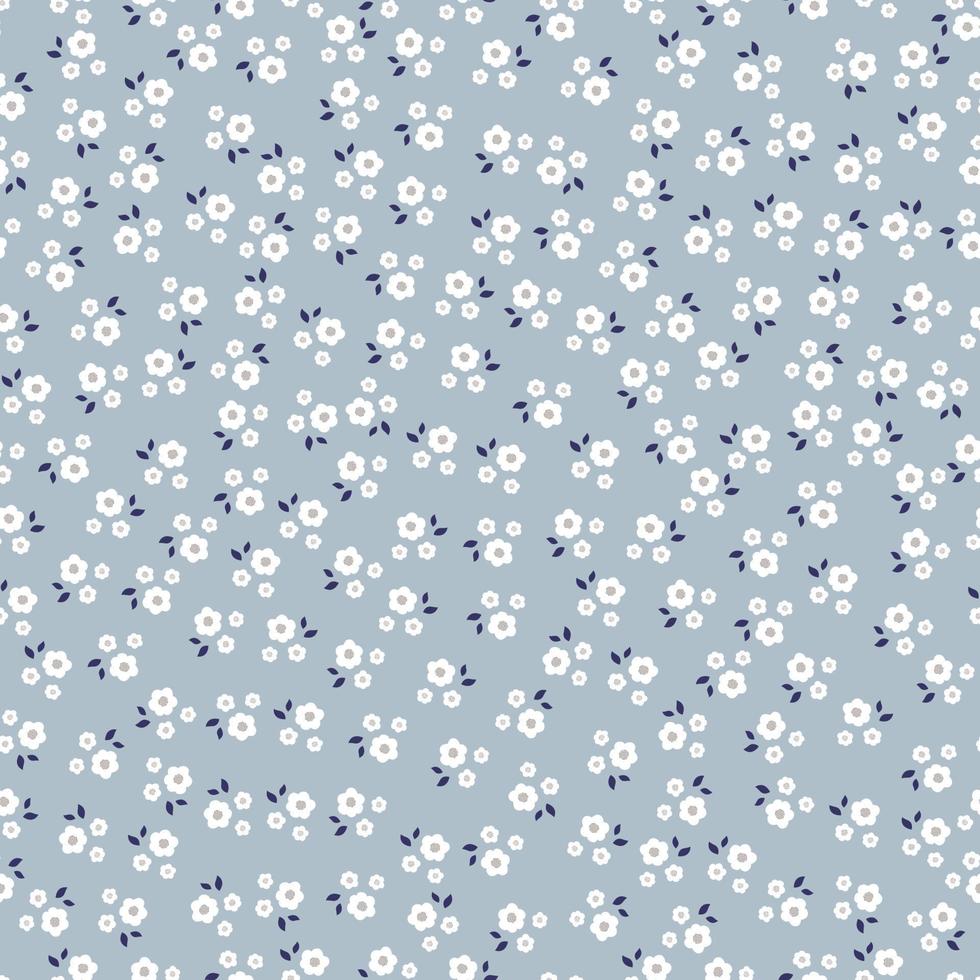 vackra sömlösa mönster små och stora blommiga bakgrund placerade slumpmässigt fördelade på en blå bakgrund. designen som används för tyg, textil, publikation, presentförpackning, vektorillustration. vektor