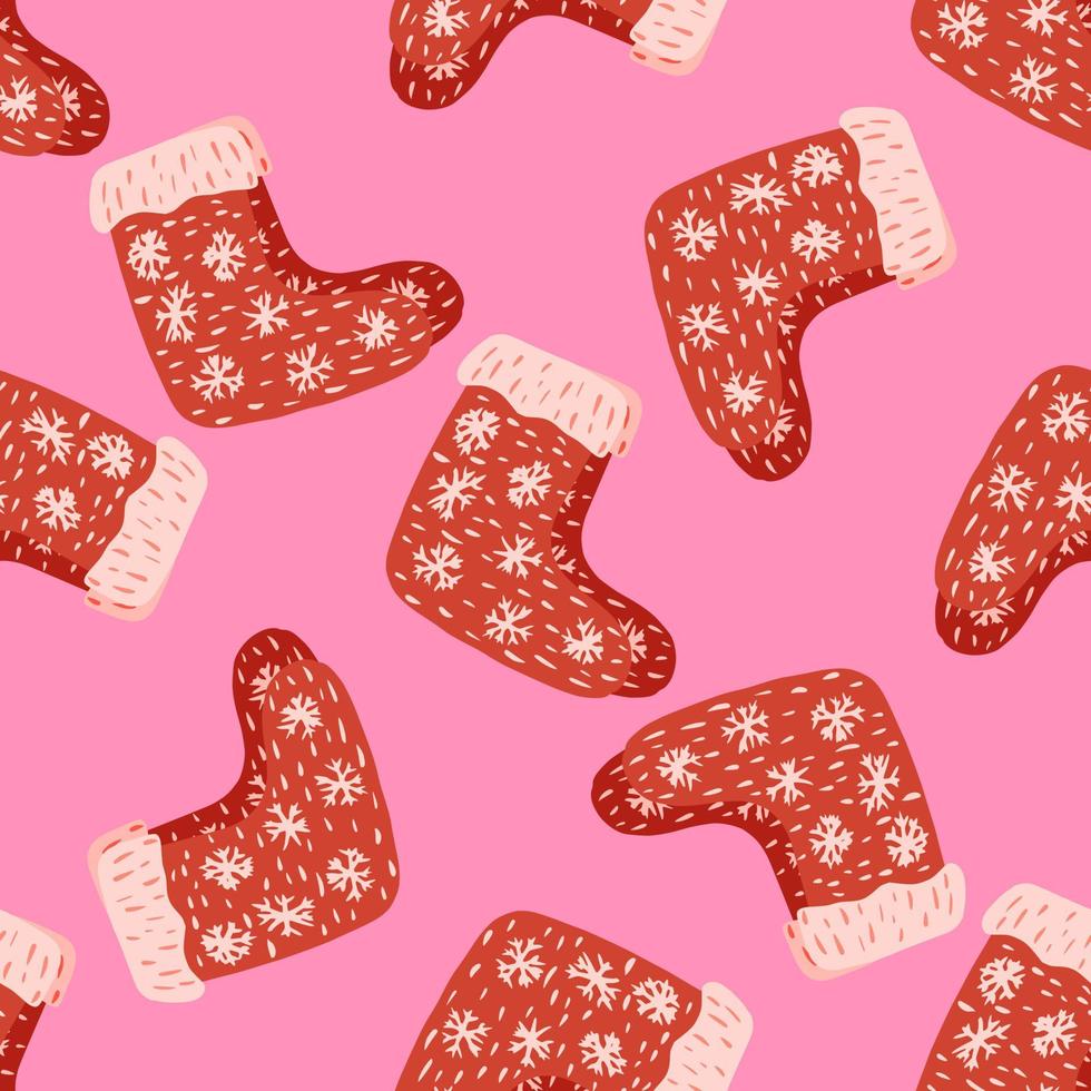 ljusa xmas sömlösa doodle mönster med dekorativa röda vinterskor element. rosa bakgrund. vektor