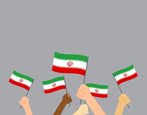 Übergeben Sie das Halten der Iran-Flaggen, die auf grauem Hintergrund lokalisiert werden vektor