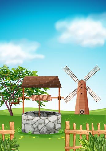 Szene mit Windmühle und Brunnen im Bauernhof vektor