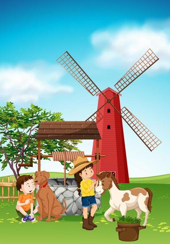Kinder und Tiere auf dem Hof mit Windmühle vektor