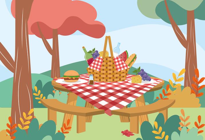 Picknickkorb mit Tischdecke und Lebensmittel auf Tabelle im Park vektor