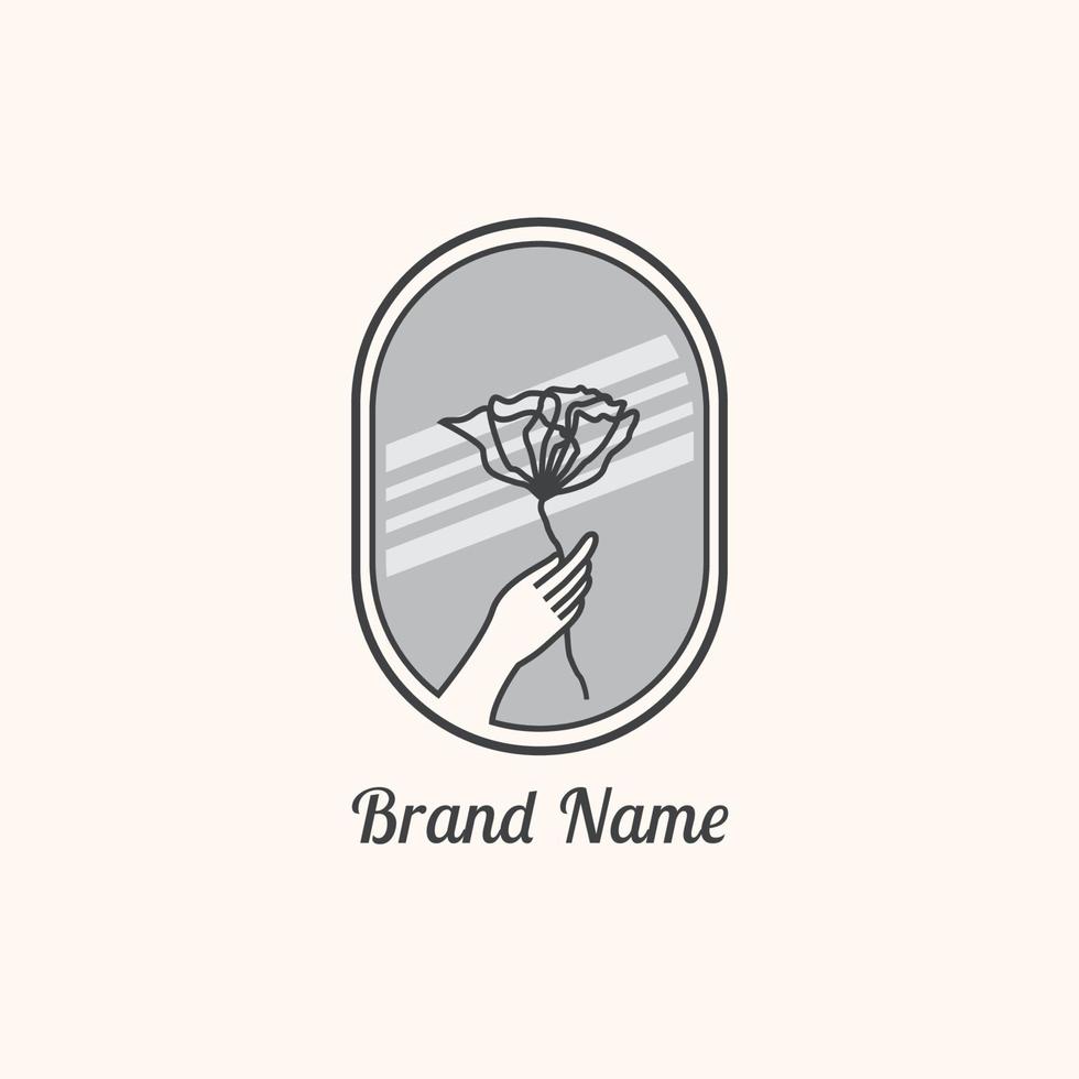 vintage hand och blomma logotyp design vektor