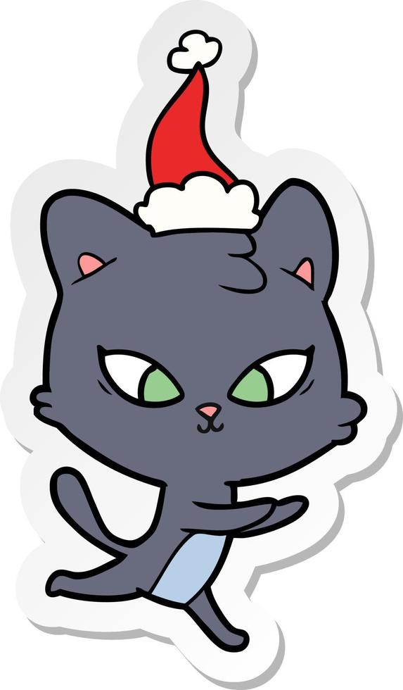 söt klistermärke tecknad av en katt som bär tomtehatt vektor