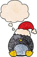 niedlicher Cartoon-Pinguin mit Weihnachtsmütze und Gedankenblase im Grunge-Texturmuster-Stil vektor