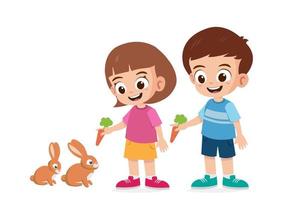süße kleine Mädchen und Jungen, die Kaninchen mit Karotten füttern, Vektorgrafiken vektor