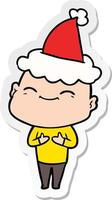 Fröhlicher Aufkleber-Cartoon eines glatzköpfigen Mannes mit Weihnachtsmütze vektor
