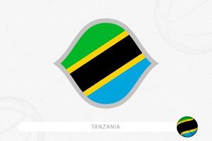 tansania-flagge für basketballwettbewerb auf grauem basketballhintergrund. vektor