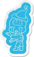 tecknad serie klistermärke av en stor hjärna utomjording gråt och pekande bär santa hatt vektor