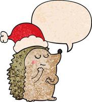 Cartoon-Igel mit Weihnachtsmütze und Sprechblase im Retro-Textur-Stil vektor