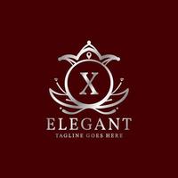brev x elegant löv och krona vapen vektor logotyp design