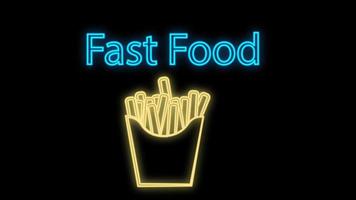franska frites i neon stil på en svart bakgrund, vektor illustration. gul neon med snabb mat inskrift. neon tecken för kaféer och restauranger