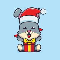 süßes kaninchen glücklich mit weihnachtsgeschenk. nette weihnachtskarikaturillustration. vektor