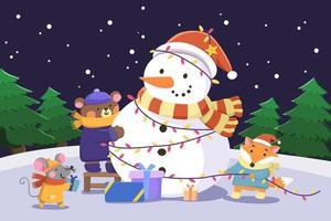 Weihnachtskartendesign. flache illustration von maus, bär und wolf, die einen schneemann mit weihnachtslichterketten und geschenkboxen in einer verschneiten nacht im freien schmücken vektor