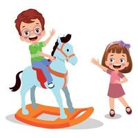 Lycklig pojke svängande på leksak häst vektor