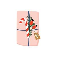 geschenkbox verpackt mit rosa papier, schnur, zuckerstange, kiefer und etikett. Winterurlaub vorhanden. einzelne Vektorillustration im flachen Stil. vektor