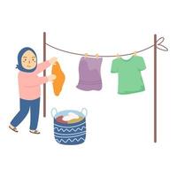 Frau Hijab hängt nasse Kleidung zum Trocknen auf vektor