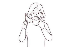 leende flicka med tandborste visa på vit rena tänder. Lycklig barn rekommendera tänder pensling och oral vård. dental vård begrepp. vektor illustration.
