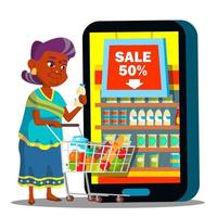 Online-Shopping-Vektor. alte frau, die mit einkaufswagen steht und lebensmittel online kauft. Illustration vektor