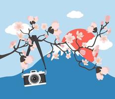 Kamera hängt mit rosa Blumenzweig am Berg Fuji vektor