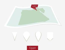 gebogen Papier Karte von Ägypten mit Hauptstadt Kairo auf grau Hintergrund. vier anders Karte Stift Satz. vektor