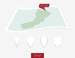 gebogen Papier Karte von Oman mit Hauptstadt Muskateller auf grau Hintergrund. vier anders Karte Stift Satz. vektor