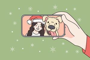 uppkopplad jul och ny år firande begrepp. mänsklig hand innehav smartphone med leende flicka och hund i santa hatt fira och hälsning uppkopplad vektor illustration