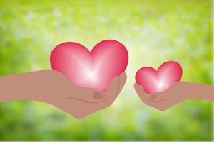 hand som håller hjärta. ge ett rosa hjärta med kärlek. suddig grön bakgrund vektor