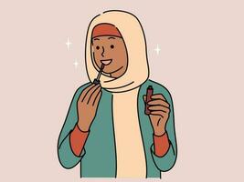 leende ung arabicum kvinna i hijab applicering läpp glans på mun. Lycklig arab flicka do smink. skönhet och kosmetika. vektor illustration.