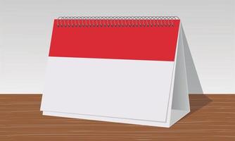 roter und weißer Kalender auf hölzernem Schreibtisch