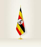 Uganda Flagge auf ein Flagge Stand. vektor