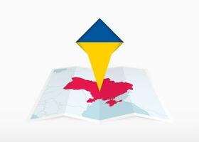 ukraina är avbildad på en vikta papper Karta och fästs plats markör med flagga av ukraina. vektor