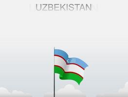 uzbekistans flagga flyger på en stolpe som står högt under den vita himlen vektor