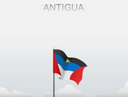 die Flagge von Antigua weht an einer Stange, die hoch unter dem weißen Himmel steht vektor