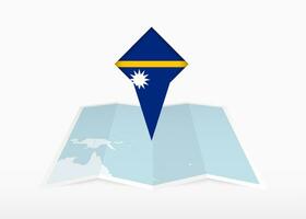 Nauru ist abgebildet auf ein gefaltet Papier Karte und festgesteckt Ort Marker mit Flagge von Nauru. vektor