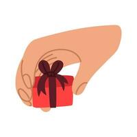 Präsentation von ein Geschenk. ein Hand mit ein klein Geschenk Box zum ein Banner, das Internet. ein Geschenk im Ihre Hand. Vektor Illustration von ein eben Stil. Finger halten ein Box mit ein Bogen, ein Band