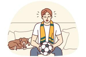 ung man sitta på soffa tittar på fotboll spel på Hem. manlig sport fläkt med boll i händer njut av match inomhus. vektor illustration.