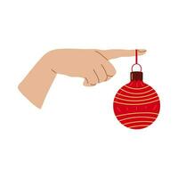 Semester Hem dekoration hand med jul boll design för baner, webb. röd boll på finger. vektor illustration...